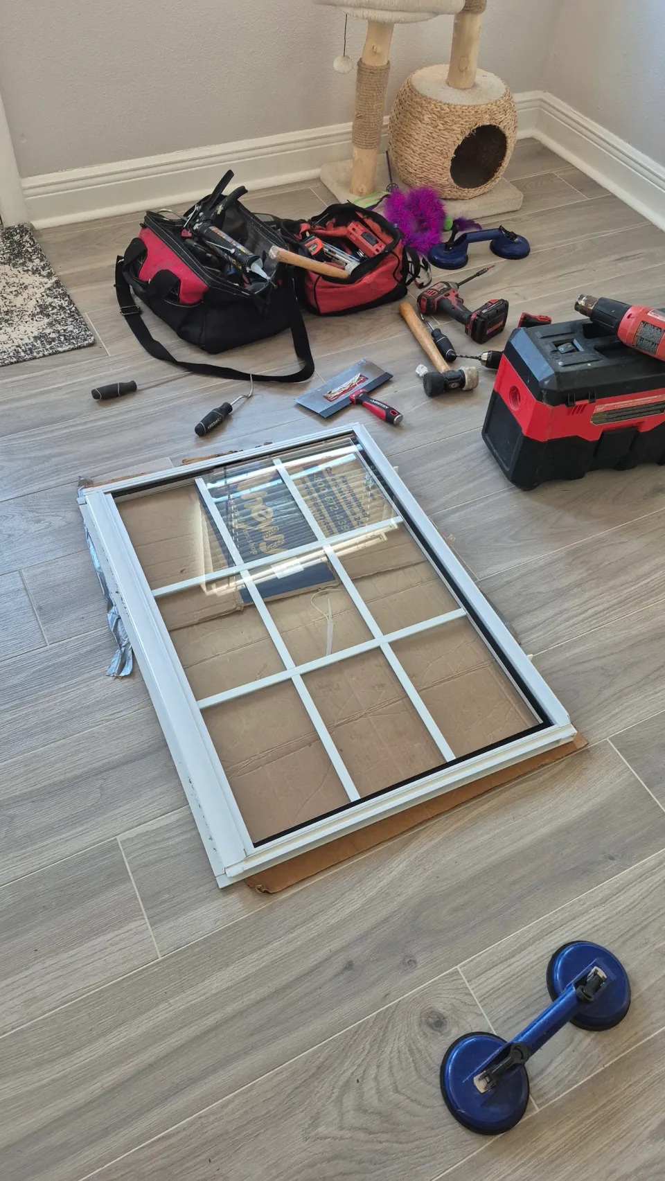 Removed window sash beside glazing tools and suction lifters